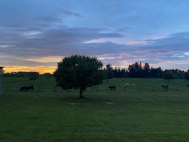 1071 S Header Canal Rd, Fort Pierce, FL 34945 - yard at dusk featuring a view of rural / pastoral area and a lawn