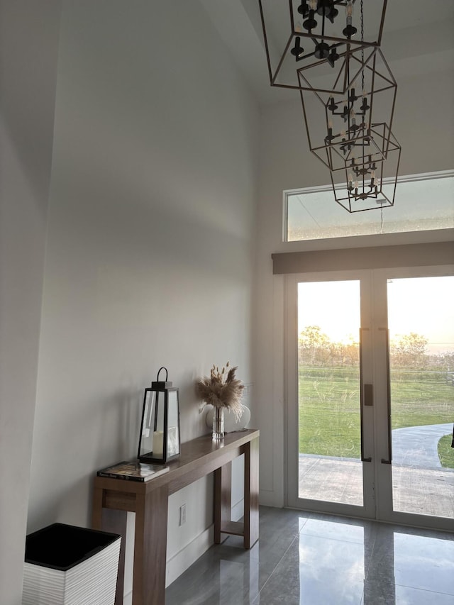 1071 S Header Canal Rd, Fort Pierce, FL 34945 - foyer featuring french doors, a chandelier, and a towering ceiling