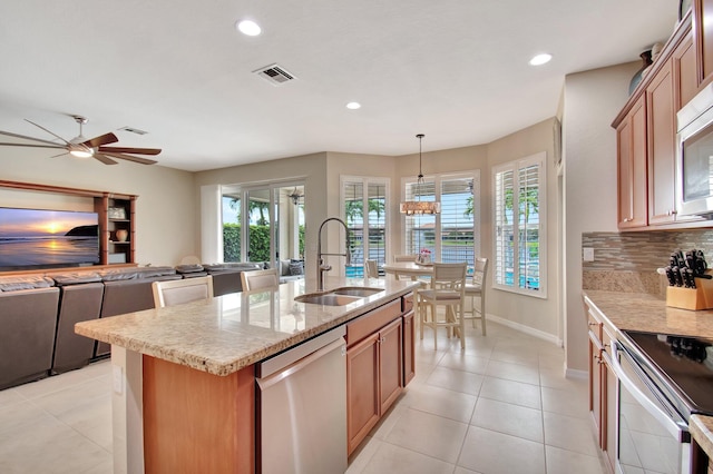 7147 Prudencia Dr, Lake Worth, FL 33463 - kitchen with a sink, stainless steel appliances, recessed lighting, decorative backsplash, and baseboards