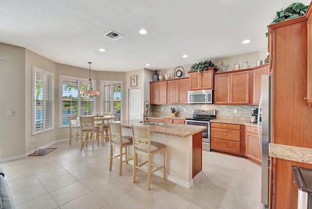 7147 Prudencia Dr, Lake Worth, FL 33463 - kitchen with appliances with stainless steel finishes, a sink, backsplash, light stone countertops, and recessed lighting
