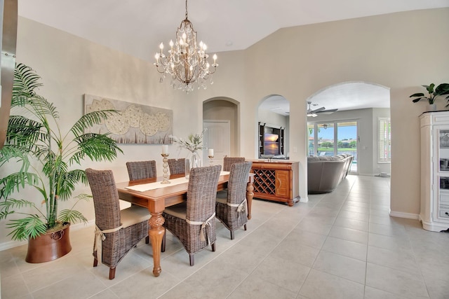 7147 Prudencia Dr, Lake Worth, FL 33463 - dining space featuring arched walkways, light tile patterned floors, a chandelier, ceiling fan, and baseboards