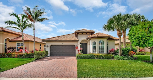 7147 Prudencia Dr, Lake Worth, FL 33463 - mediterranean / spanish house with a garage, decorative driveway, stucco siding, and a front lawn