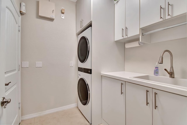 7147 Prudencia Dr, Lake Worth, FL 33463 - laundry room with stacked washer and clothes dryer, cabinet space, and baseboards