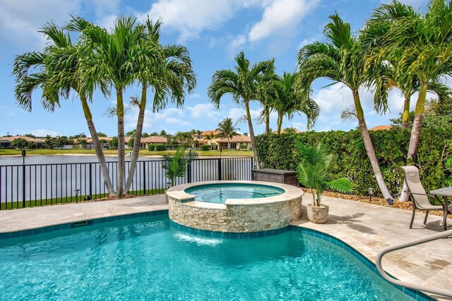 7147 Prudencia Dr, Lake Worth, FL 33463 - view of swimming pool with a water view, a pool with connected hot tub, and a patio