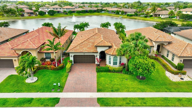 7147 Prudencia Dr, Lake Worth, FL 33463 - view of front facade featuring a residential view, a garage, stucco siding, a water view, and a tiled roof