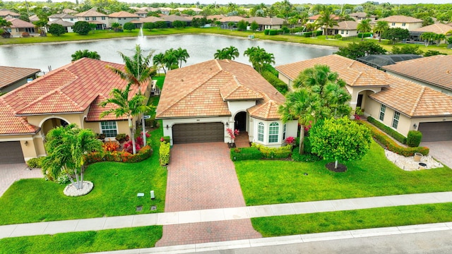 7147 Prudencia Dr, Lake Worth, FL 33463 - view of front of property with a residential view, an attached garage, stucco siding, and a water view