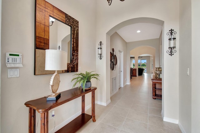 7147 Prudencia Dr, Lake Worth, FL 33463 - corridor featuring arched walkways, baseboards, and light tile patterned floors