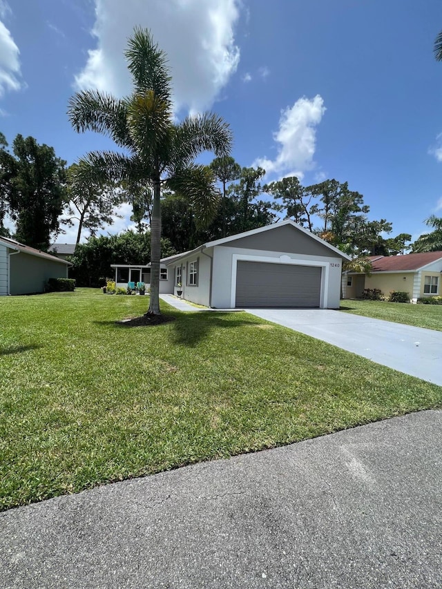 1240 Pine Sage Cir, West Palm Beach, FL 33409 - ranch-style house featuring a front yard, driveway, an attached garage, and stucco siding