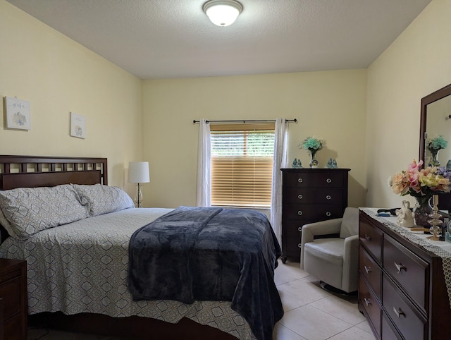 bedroom with light tile patterned flooring and a textured ceiling