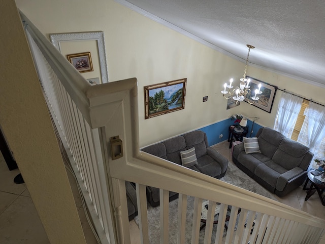 stairway featuring an inviting chandelier, ornamental molding, and a textured ceiling