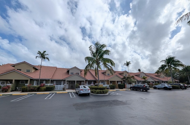 view of property featuring uncovered parking and a residential view