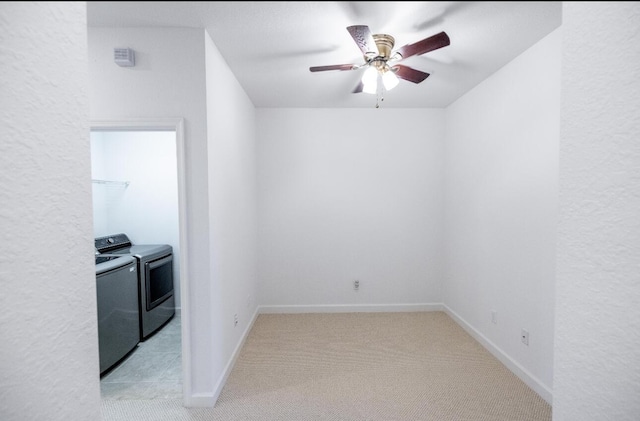 10403 Wellington Parc Dr, Wellington, FL 33449 - unfurnished room with washer and dryer, light carpet, baseboards, and a ceiling fan