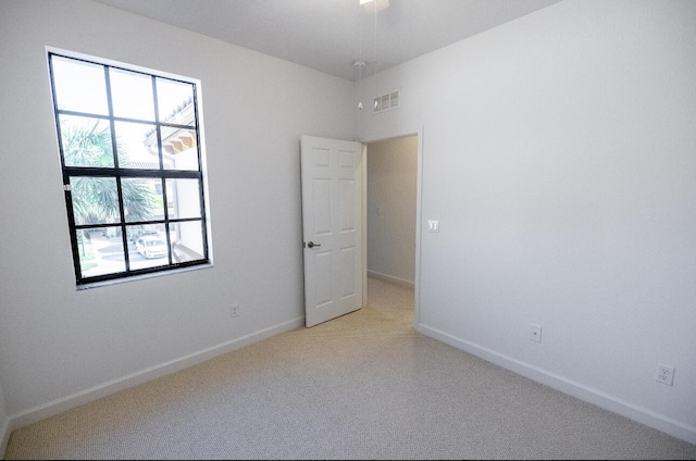 10403 Wellington Parc Dr, Wellington, FL 33449 - empty room featuring light colored carpet, baseboards, and visible vents
