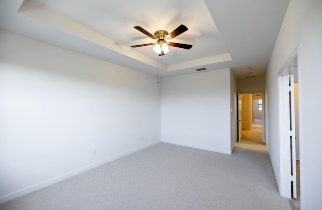 10403 Wellington Parc Dr, Wellington, FL 33449 - spare room with ceiling fan, light colored carpet, visible vents, a raised ceiling, and baseboards