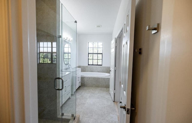10403 Wellington Parc Dr, Wellington, FL 33449 - full bathroom featuring a stall shower, tile patterned floors, a garden tub, visible vents, and a sink