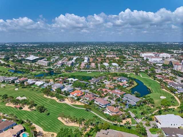 drone / aerial view featuring view of golf course and a water view