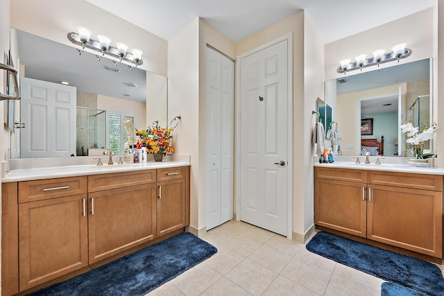 5264 Cambridge Ct, Palm Beach Gardens, FL 33418 - full bathroom featuring a shower stall, a closet, two vanities, and tile patterned floors