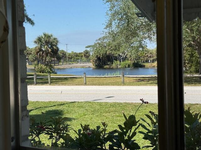 property view of water featuring fence