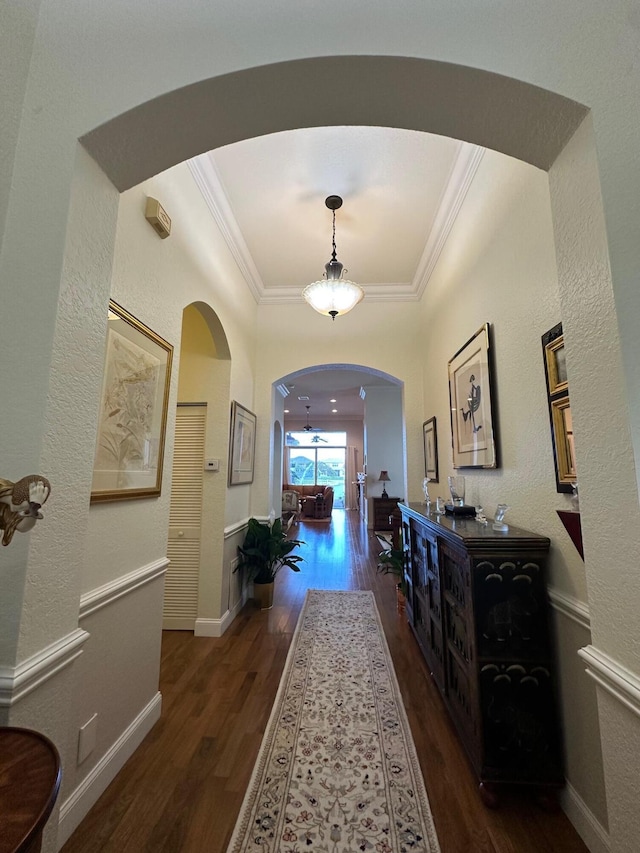 3112 Bollard Rd, West Palm Beach, FL 33411 - foyer entrance with arched walkways, wood finished floors, and crown molding