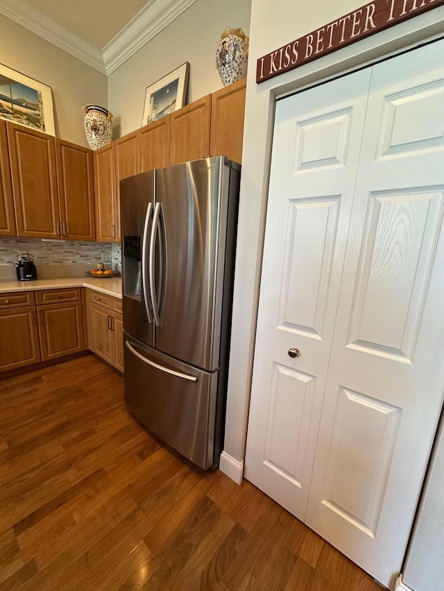 3112 Bollard Rd, West Palm Beach, FL 33411 - kitchen featuring stainless steel fridge with ice dispenser, crown molding, dark wood-style floors, light countertops, and backsplash