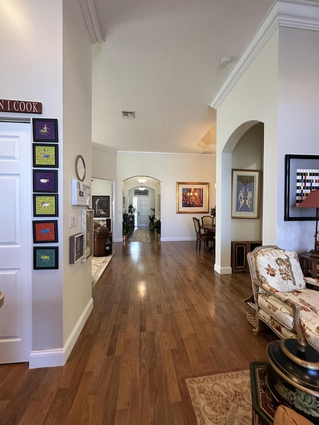 3112 Bollard Rd, West Palm Beach, FL 33411 - hallway featuring arched walkways, ornamental molding, wood finished floors, and baseboards