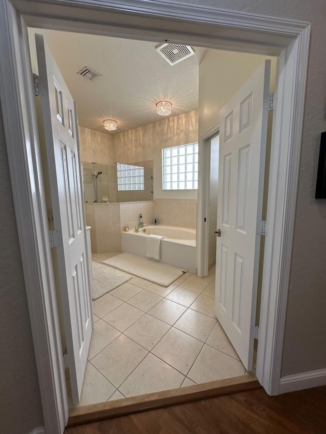 3112 Bollard Rd, West Palm Beach, FL 33411 - bathroom with a bath and tile patterned floors