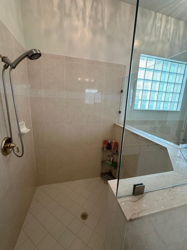 3112 Bollard Rd, West Palm Beach, FL 33411 - bathroom featuring a tile shower and tile patterned flooring