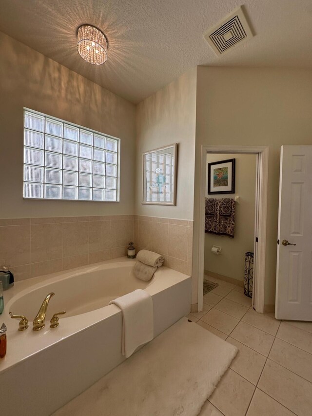 3112 Bollard Rd, West Palm Beach, FL 33411 - bathroom with tile patterned flooring and a garden tub