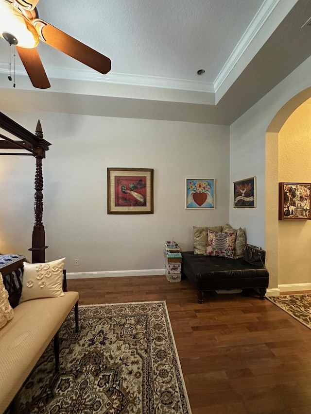 3112 Bollard Rd, West Palm Beach, FL 33411 - living area with ornamental molding, arched walkways, wood finished floors, ceiling fan, and a tray ceiling