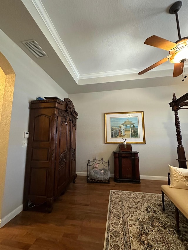 3112 Bollard Rd, West Palm Beach, FL 33411 - living area with dark wood-style flooring, a ceiling fan, arched walkways, and ornamental molding