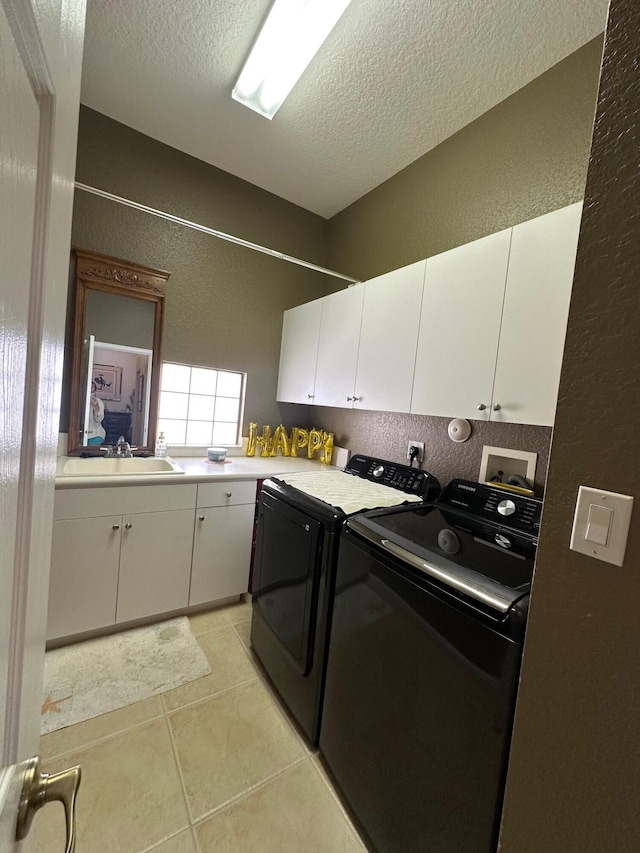 3112 Bollard Rd, West Palm Beach, FL 33411 - washroom with cabinet space, a textured wall, washing machine and dryer, a textured ceiling, and light tile patterned floors