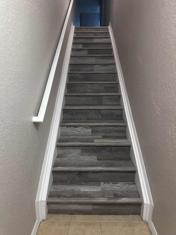 162 SW Peacock Blvd Unit 205, Port Saint Lucie, FL 34986 - stairs featuring tile patterned floors and a textured wall
