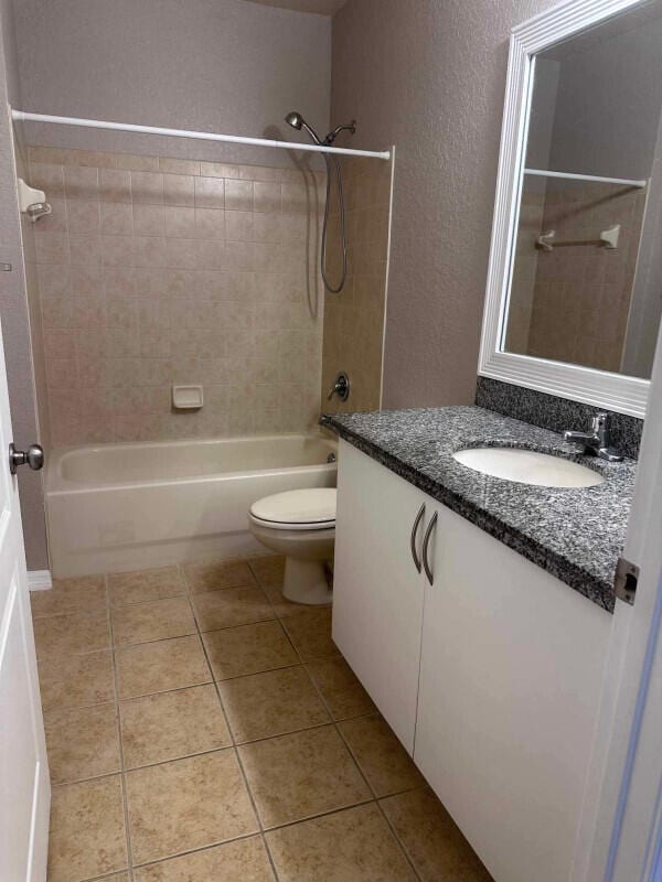 162 SW Peacock Blvd Unit 205, Port Saint Lucie, FL 34986 - bathroom with toilet, tub / shower combination, vanity, tile patterned flooring, and a textured wall