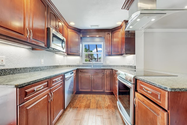 kitchen featuring ventilation hood, light wood-type flooring, stone counters, crown molding, and appliances with stainless steel finishes