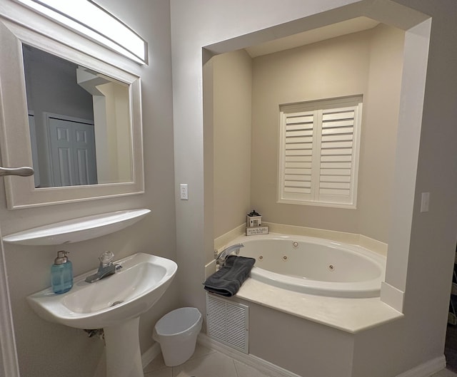 9851 Perfect Dr Unit 151, Port Saint Lucie, FL 34986 - bathroom with a whirlpool tub and tile patterned flooring