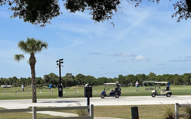 9851 Perfect Dr Unit 151, Port Saint Lucie, FL 34986 - view of community featuring a lawn and view of wooded area