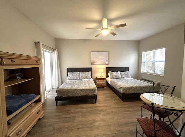 9851 Perfect Dr Unit 151, Port Saint Lucie, FL 34986 - bedroom with dark wood-type flooring, a wall mounted AC, and a ceiling fan