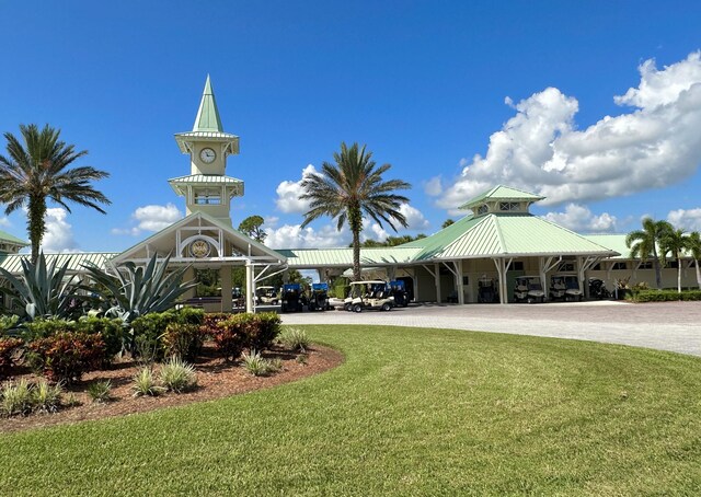9851 Perfect Dr Unit 151, Port Saint Lucie, FL 34986 - view of property's community featuring a lawn, driveway, and a carport