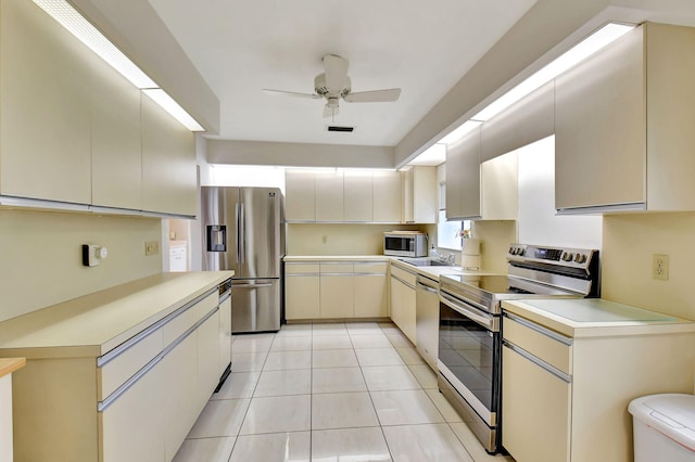 45 Eastgate Dr Unit B, Boynton Beach, FL 33436 - kitchen with cream cabinets, light countertops, visible vents, and stainless steel appliances
