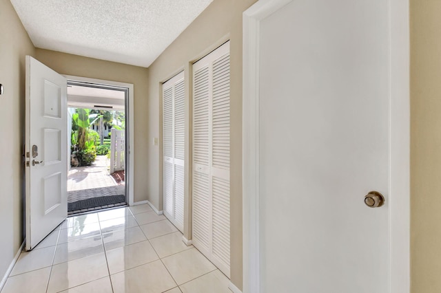 45 Eastgate Dr Unit B, Boynton Beach, FL 33436 - bedroom with light wood-style flooring, a textured ceiling, access to exterior, and baseboards