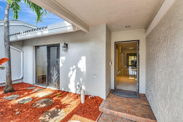 45 Eastgate Dr Unit B, Boynton Beach, FL 33436 - hallway with baseboards, light tile patterned flooring, and a textured ceiling