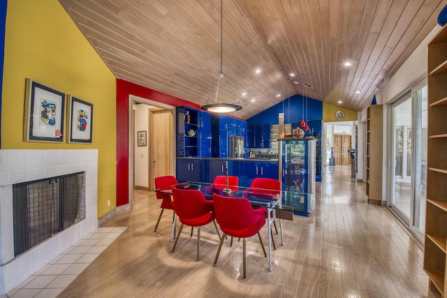 1440 Breakers W Blvd, West Palm Beach, FL 33411 - dining area with wooden ceiling, lofted ceiling, light wood-style flooring, a tiled fireplace, and baseboards