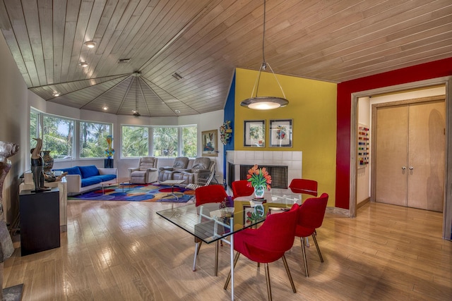 1440 Breakers W Blvd, West Palm Beach, FL 33411 - dining room featuring wood finished floors, lofted ceiling, and a tile fireplace