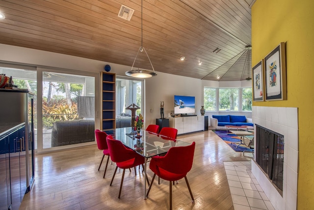 1440 Breakers W Blvd, West Palm Beach, FL 33411 - dining space featuring a tile fireplace, wood ceiling, hardwood / wood-style flooring, and lofted ceiling