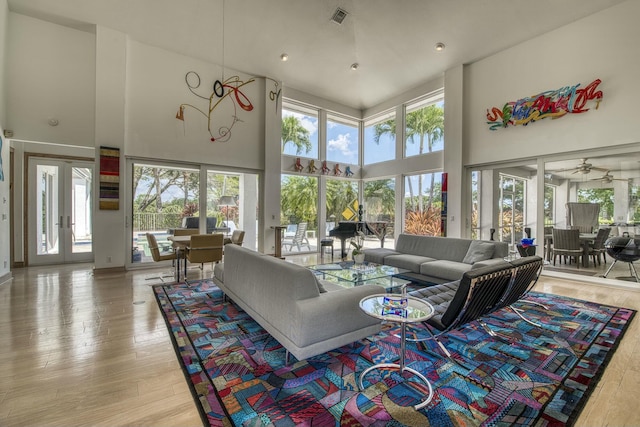 1440 Breakers W Blvd, West Palm Beach, FL 33411 - living area featuring a towering ceiling, healthy amount of natural light, wood-type flooring, and ceiling fan