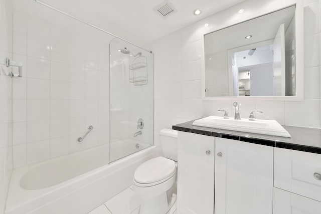 3215 S Ocean Blvd Unit 707, Highland Beach, FL 33487 - bathroom featuring tile walls, toilet, vanity, bathing tub / shower combination, and tasteful backsplash