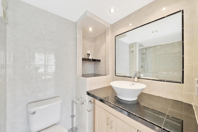 3215 S Ocean Blvd Unit 707, Highland Beach, FL 33487 - full bath with tile walls, a shower stall, toilet, and vanity