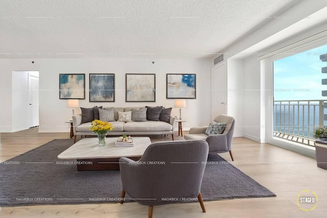 3215 S Ocean Blvd Unit 707, Highland Beach, FL 33487 - living room with a textured ceiling, baseboards, and wood finished floors
