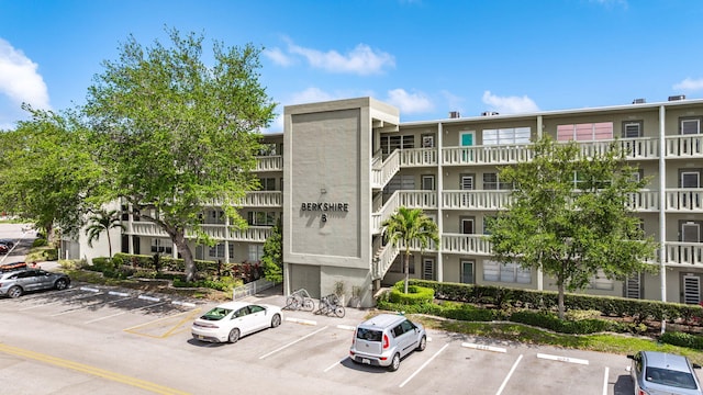 view of building exterior with uncovered parking
