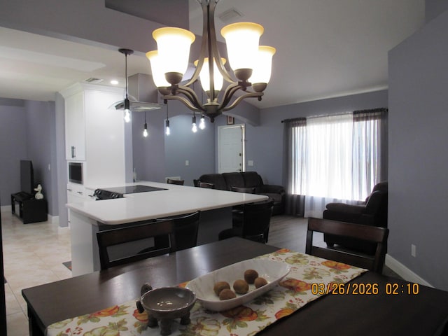 443 SW Homeland Rd, Port Saint Lucie, FL 34953 - dining space with baseboards, light tile patterned floors, and an inviting chandelier